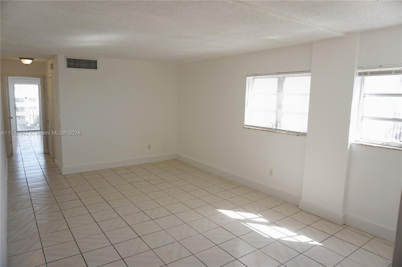 1340 Lincoln Road, Unit 608 Miami Beach, FL 33139 - Photo 3 of 10 an empty room with windows