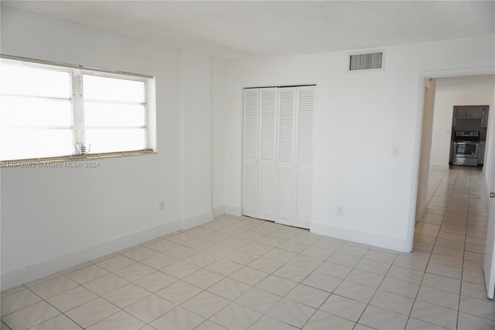 1340 Lincoln Road, Unit 608 Miami Beach, FL 33139 - Photo 7 of 10 an empty room with windows