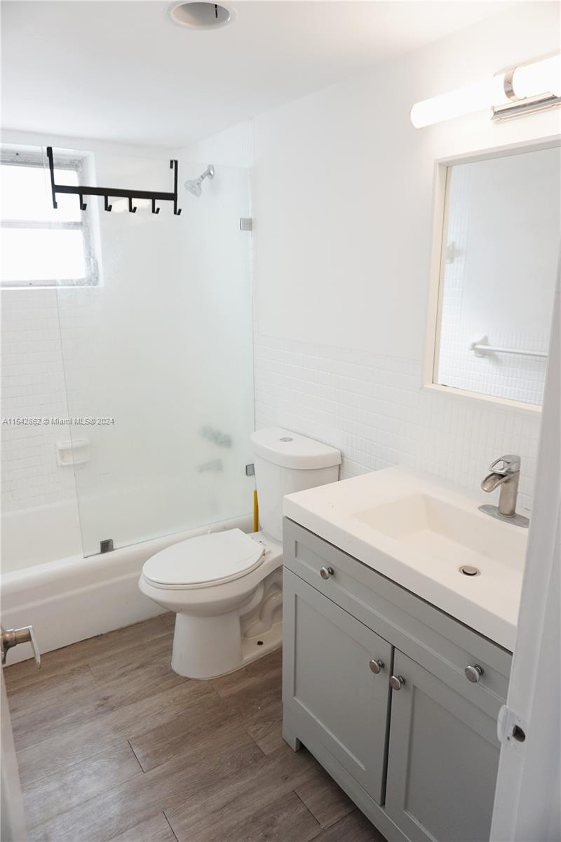 1340 Lincoln Road, Unit 608 Miami Beach, FL 33139 - Photo 8 of 10 a bathroom with a sink a toilet and shower