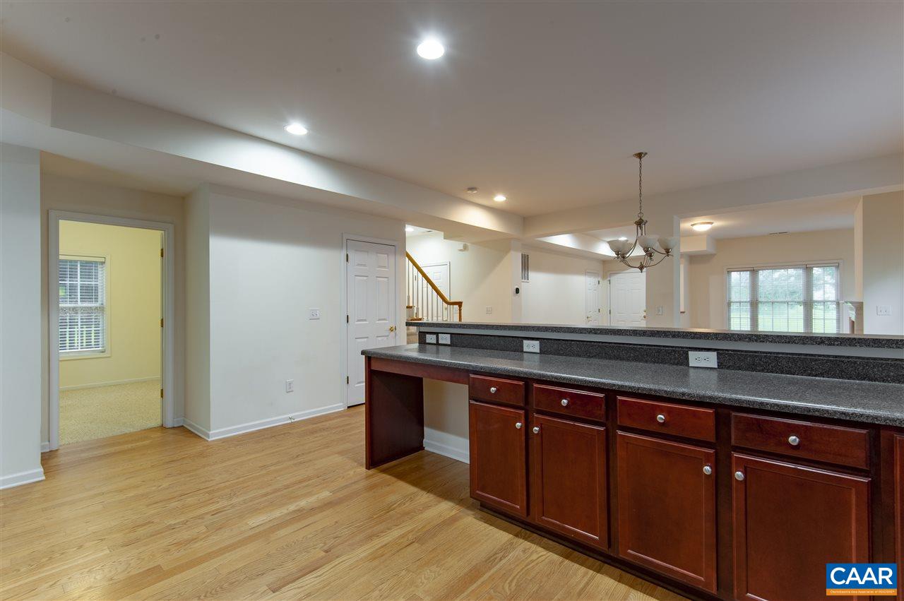 907 Raymond Road Charlottesville, VA 22902 - Photo 13 of 34 a large kitchen with stainless steel appliances granite countertop a sink and a wooden floors