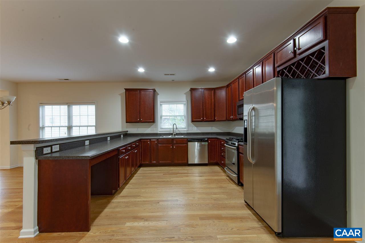 907 Raymond Road Charlottesville, VA 22902 - Photo 9 of 34 a large kitchen with stainless steel appliances granite countertop a refrigerator a sink and wooden cabinets