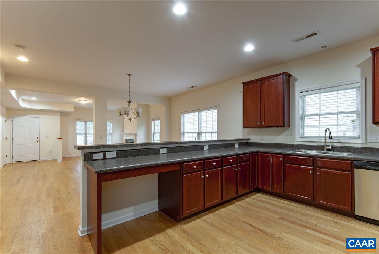 907 Raymond Road Charlottesville, VA 22902 - Photo 10 of 34 a large kitchen with wooden cabinets and dishwasher
