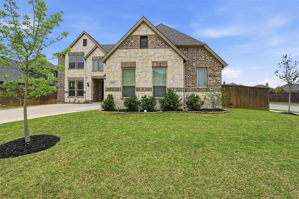 4002 Grove Valley Road Midlothian, TX 76065 - Photo 3 of 40 a view of a house with backyard and garden