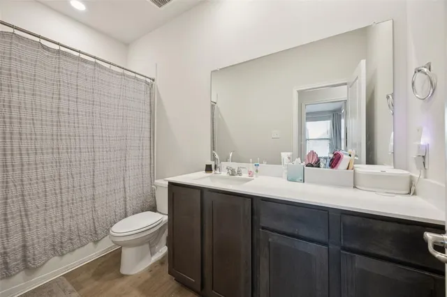 a bathroom with a sink mirror toilet and shower
