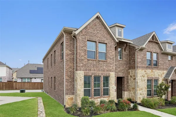 a view of a big house with a yard