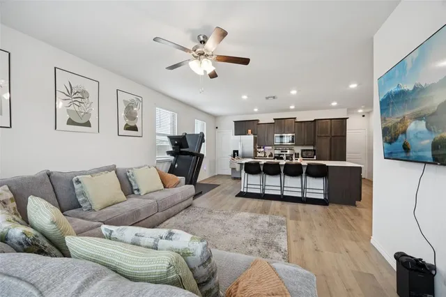a living room with furniture and kitchen view