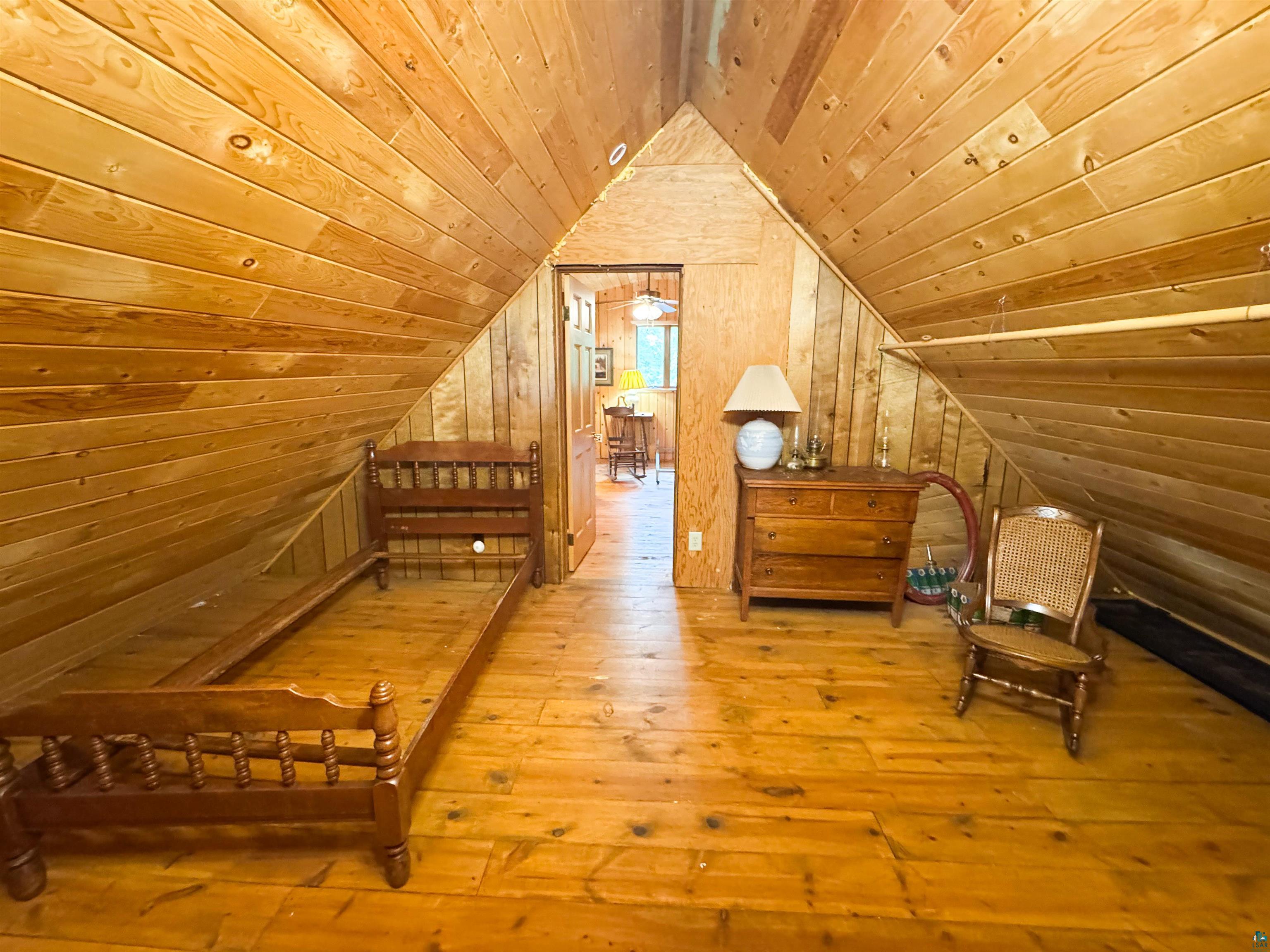 465 South Gunflint Lake Road Grand Marais, MN 55604 - Photo 44 of 46 Vaulted ceiling room with wood-finish flooring, wood plank walls, and a wood plank ceiling