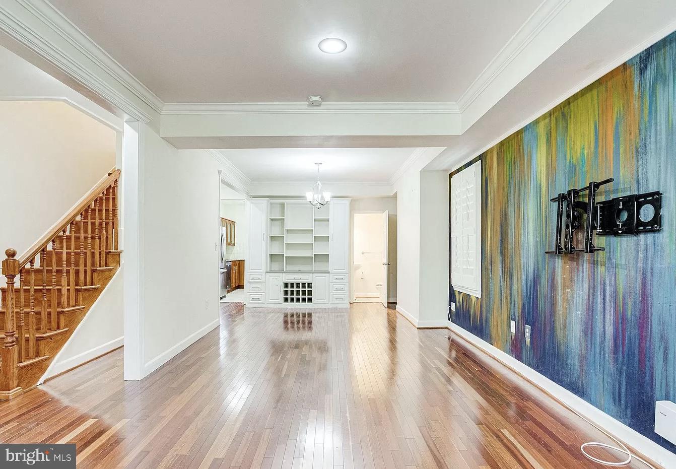 a view of entryway with wooden floor and stairs