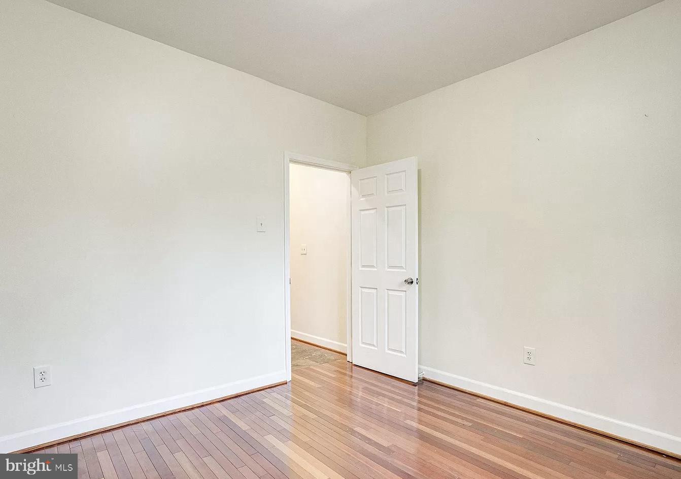 595 Columbia Road Northwest Washington, DC 20001 - Photo 16 of 36 a view of an empty room and wooden floor