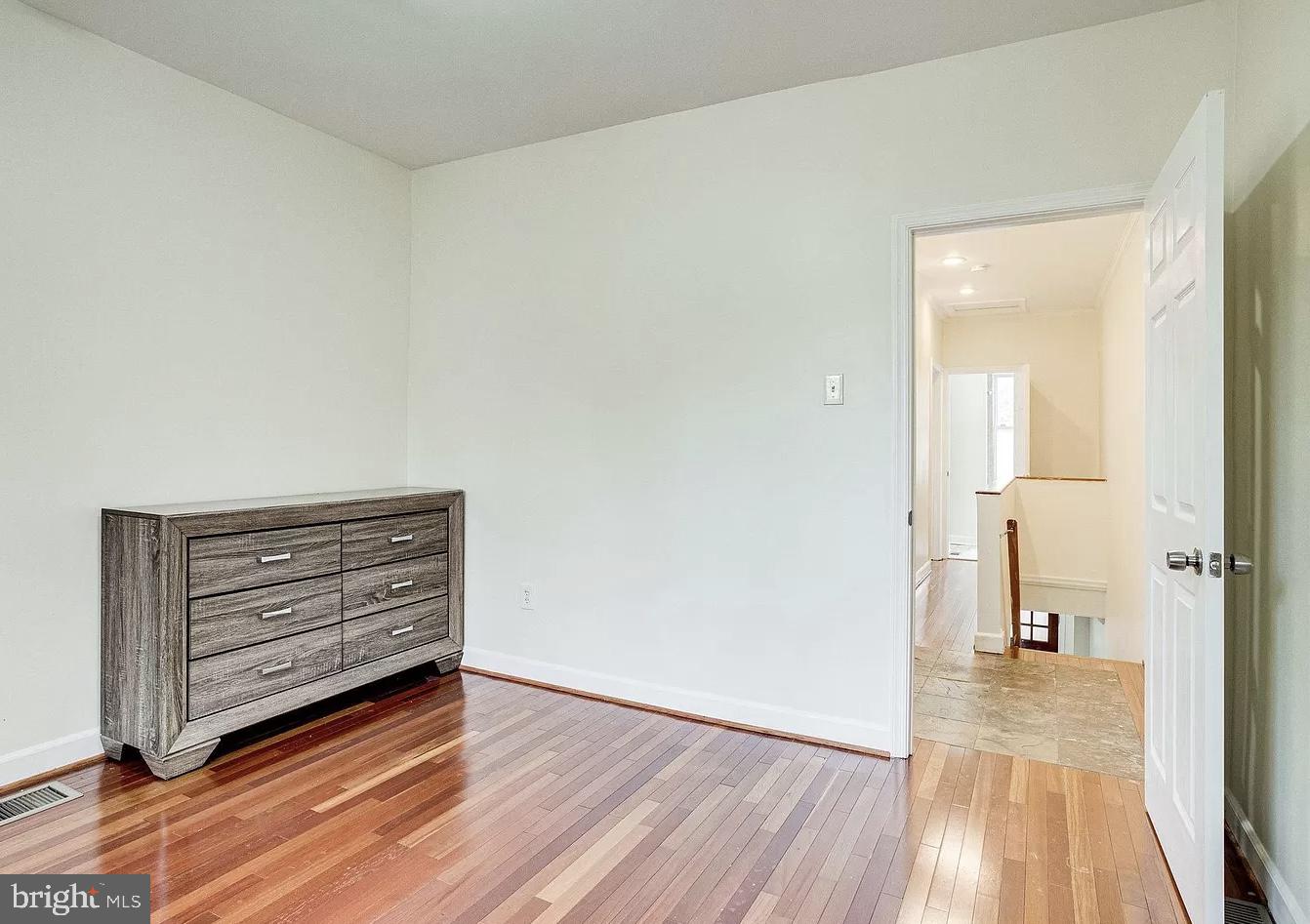 595 Columbia Road Northwest Washington, DC 20001 - Photo 17 of 36 a view of room and wooden floor
