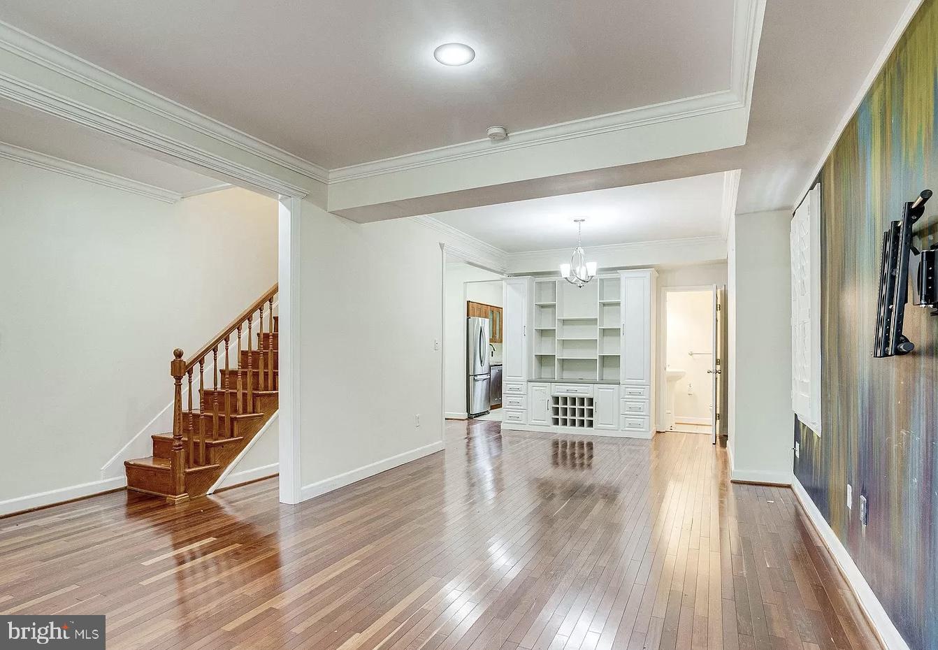 595 Columbia Road Northwest Washington, DC 20001 - Photo 2 of 36 a view of hallway with wooden floor and stairs