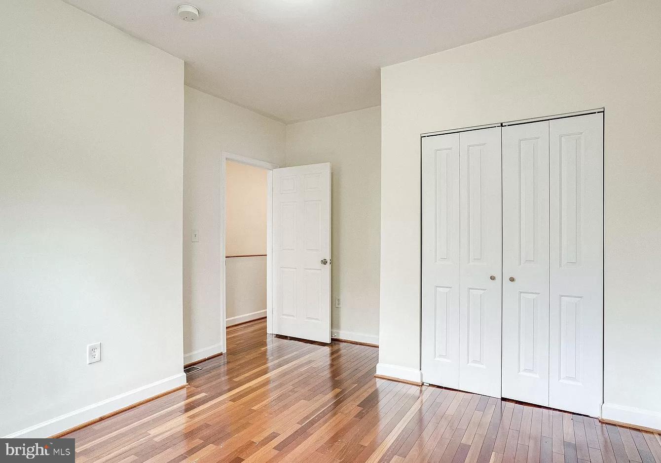 595 Columbia Road Northwest Washington, DC 20001 - Photo 22 of 36 a view of an empty room with wooden floor