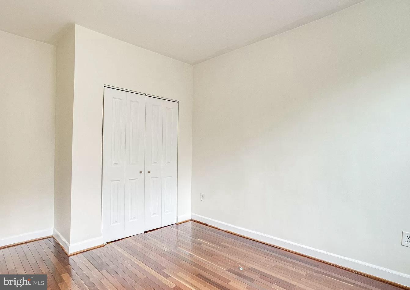 595 Columbia Road Northwest Washington, DC 20001 - Photo 23 of 36 a view of an empty room with wooden floor