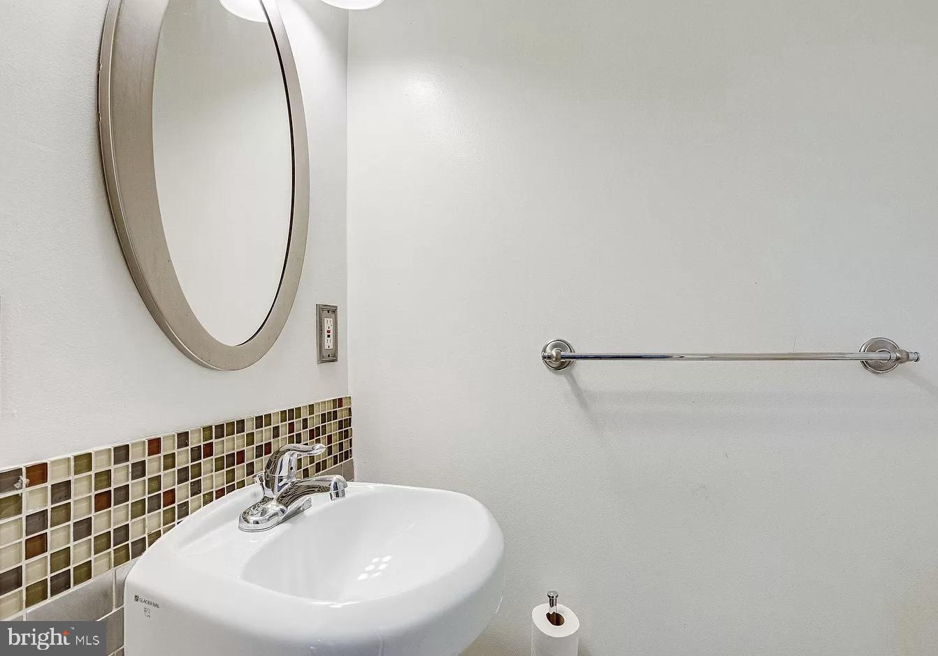595 Columbia Road Northwest Washington, DC 20001 - Photo 7 of 36 a bathroom with a sink and a mirror