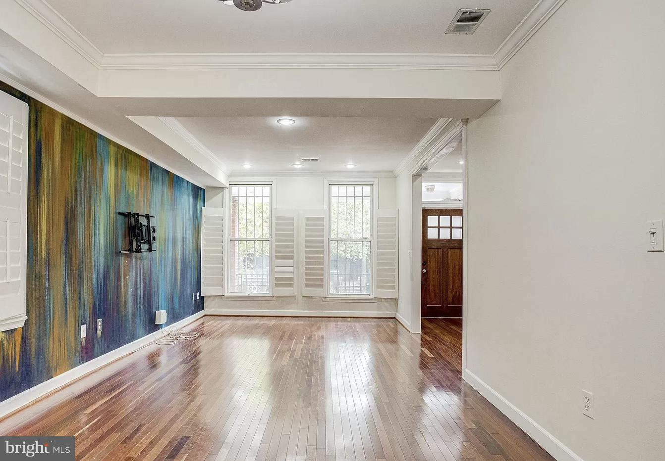 595 Columbia Road Northwest Washington, DC 20001 - Photo 9 of 36 a view of wooden floor and windows in a room