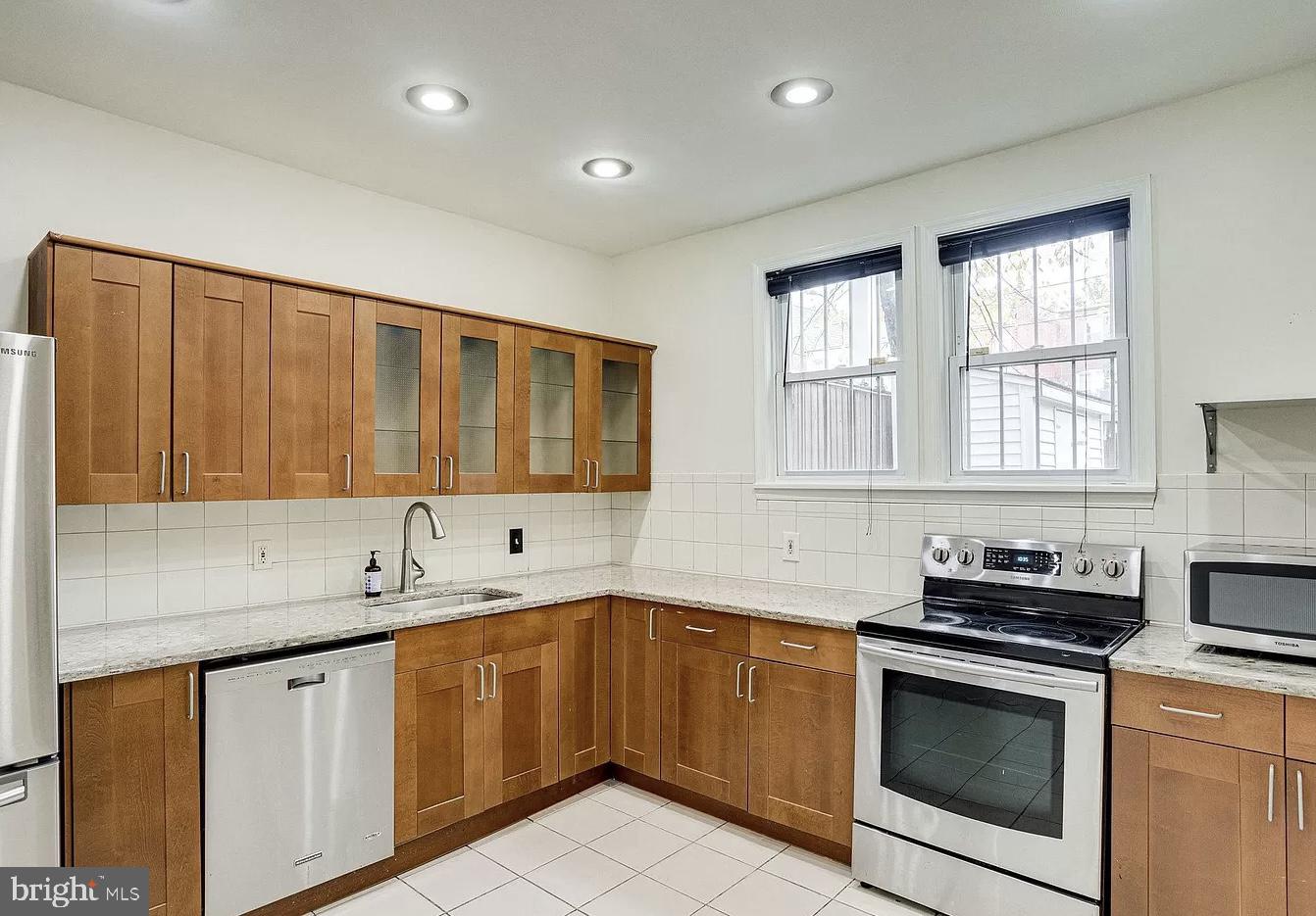 595 Columbia Road Northwest Washington, DC 20001 - Photo 10 of 36 a kitchen with a sink stove and cabinets