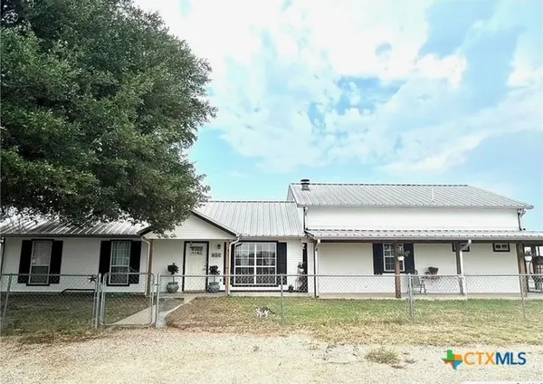 a house that has a tree in front of it