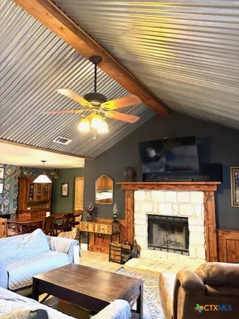 a living room with fireplace furniture and a large window