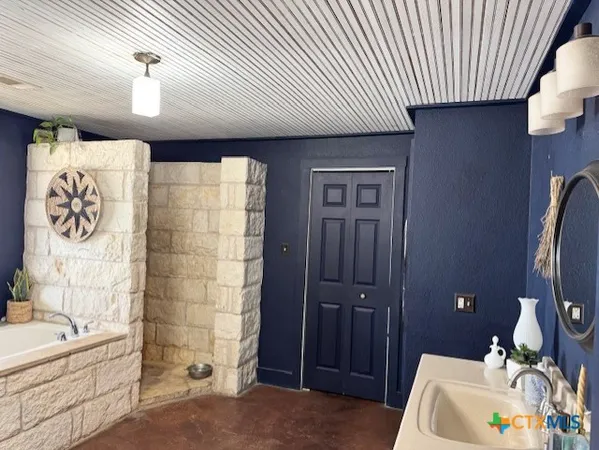 a bathroom with a bathtub and shower