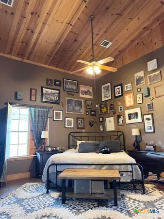 a spacious bedroom with a bed a table and chair