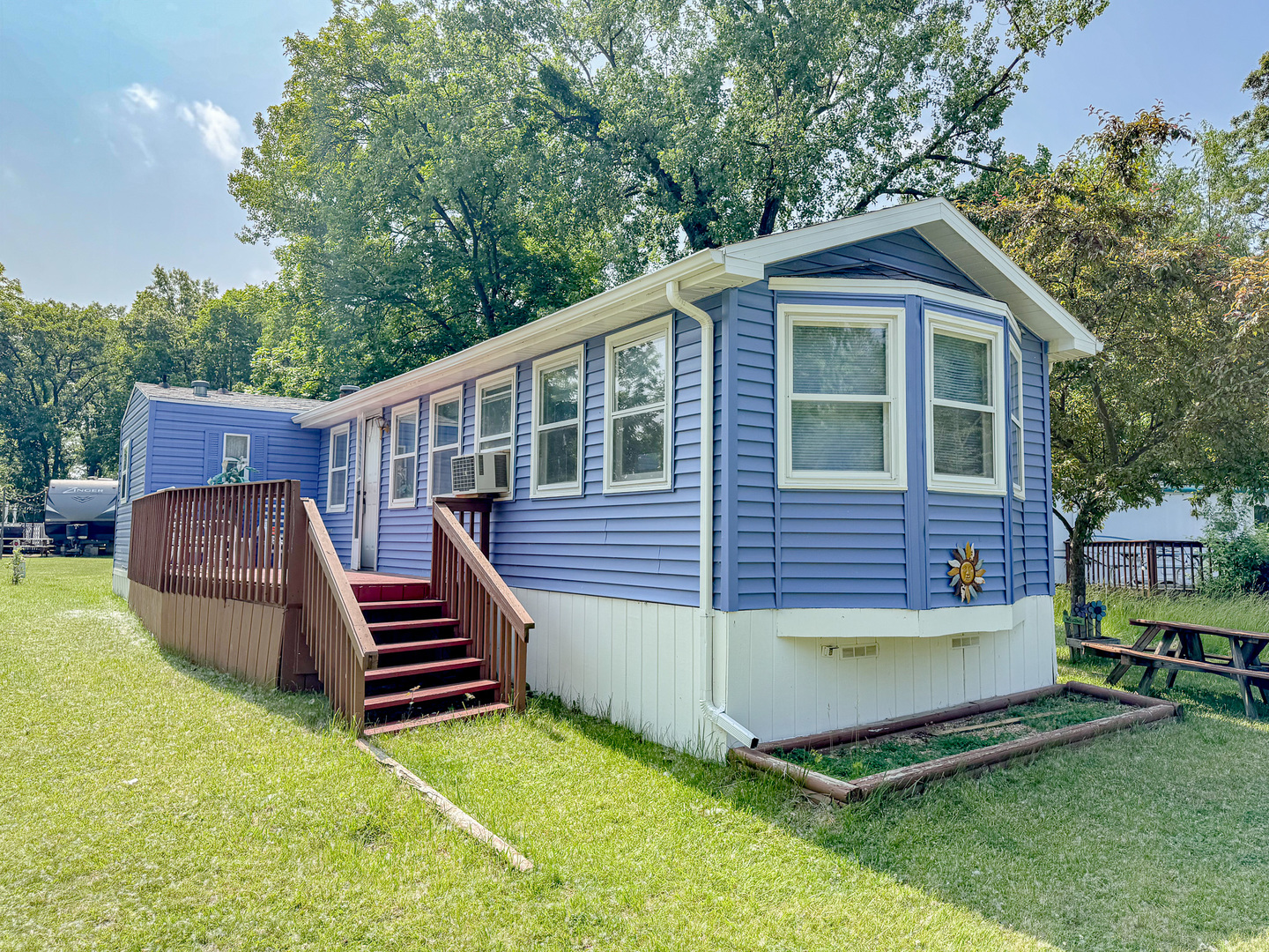 a view of a house with a yard and deck