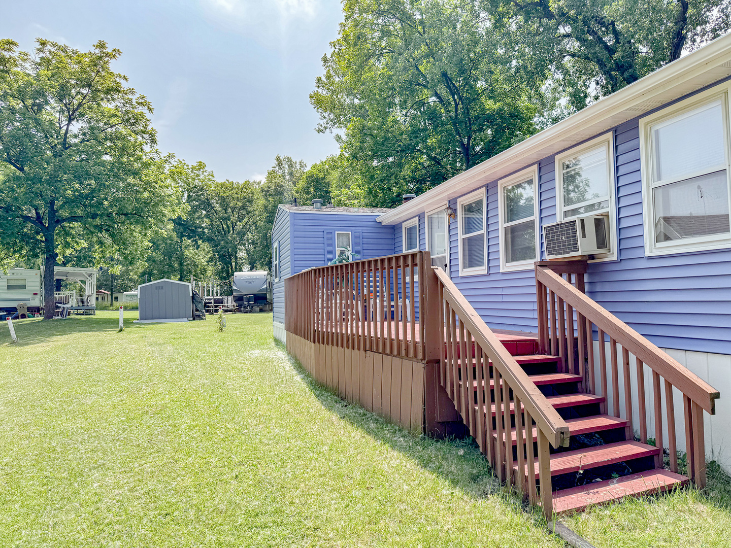 11-221 Woodhaven Sublette, IL 61367 - Photo 9 of 22 a view of a roof deck with wooden fence and a floor to ceiling window