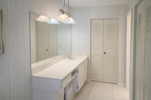 5140 Poppy Place, Unit B Delray Beach, FL 33484 - Photo 7 of 14 a bathroom with a sink and a mirror