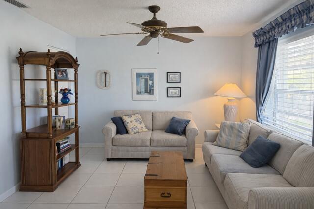 5140 Poppy Place, Unit B Delray Beach, FL 33484 - Photo 8 of 14 a living room with furniture and a window