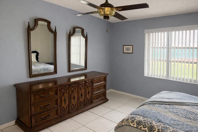 5140 Poppy Place, Unit B Delray Beach, FL 33484 - Photo 10 of 14 a bedroom with a bed and a window