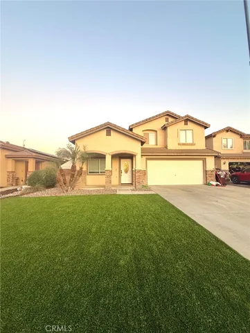 a view of a big house with a big yard and large trees