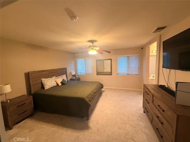 a spacious bathroom with a granite countertop sink a toilet and a mirror