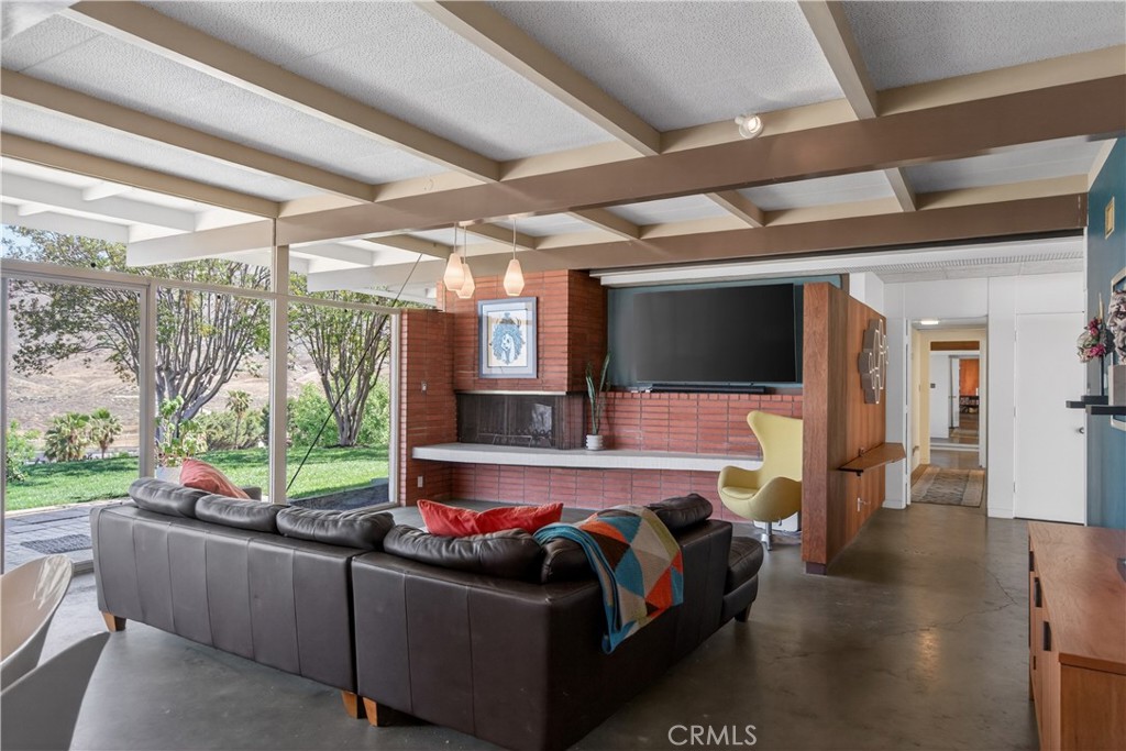 11407 Eton Lane Riverside, CA 92507 - Photo 15 of 47 a living room with couch a flat screen tv and a floor to ceiling window