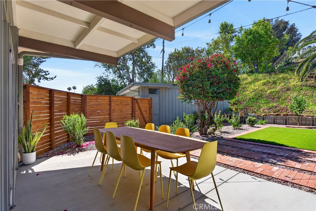 11407 Eton Lane Riverside, CA 92507 - Photo 44 of 47 a view of a patio with table and chairs potted plants and a palm tree