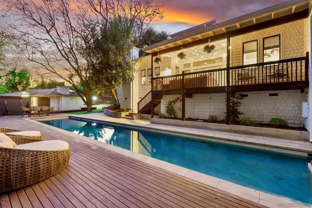 a view of a house with pool and wooden floor