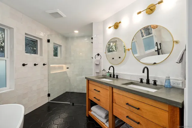 a bathroom with a double vanity sink and mirror