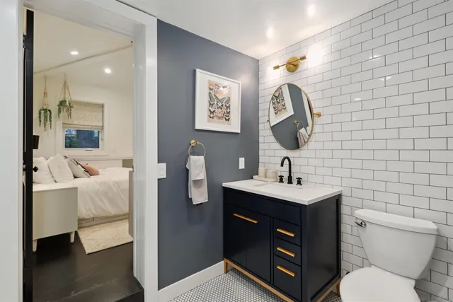 a bathroom with a toilet sink and mirror