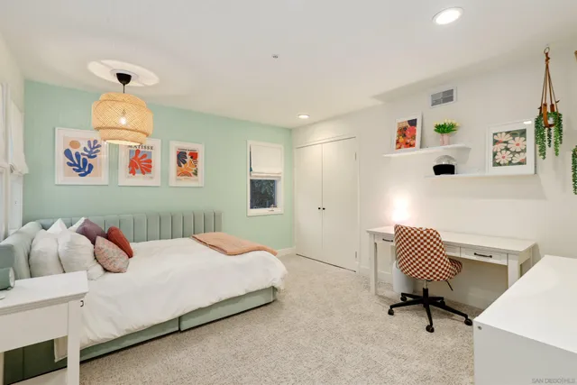 a bedroom with a bed and a chair