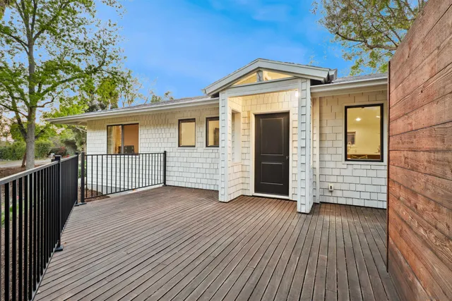 a view of a house with wooden deck