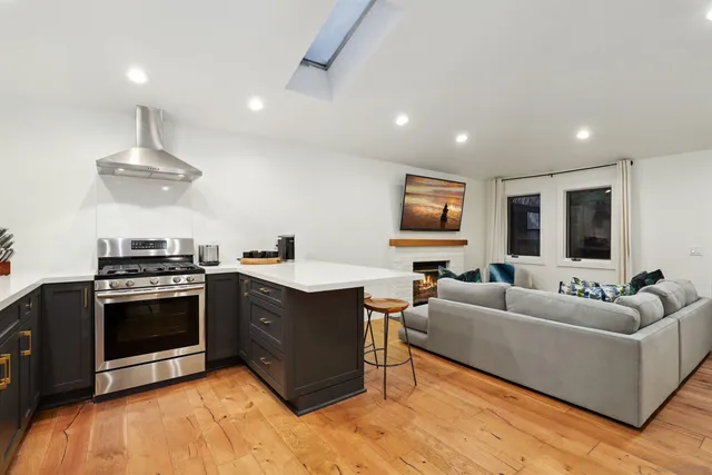 a kitchen with stainless steel appliances granite countertop a sink and a stove