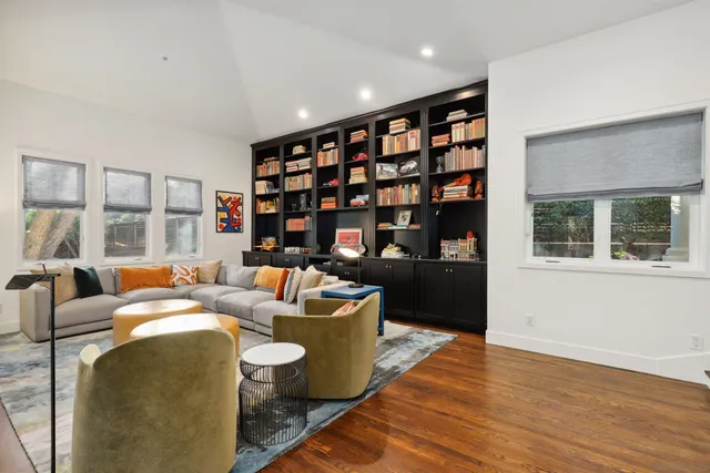 a living room with fireplace furniture and a book shelf