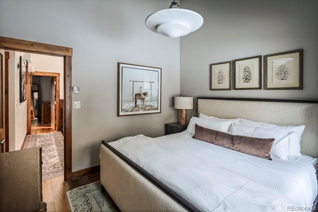 1670 Fallridge Place, Unit C11 Vail, CO 81657 - Photo 12 of 39 a bedroom with a large bed and a chandelier