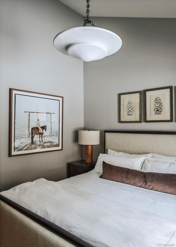 1670 Fallridge Place, Unit C11 Vail, CO 81657 - Photo 13 of 39 a bedroom with a bed and a chandelier