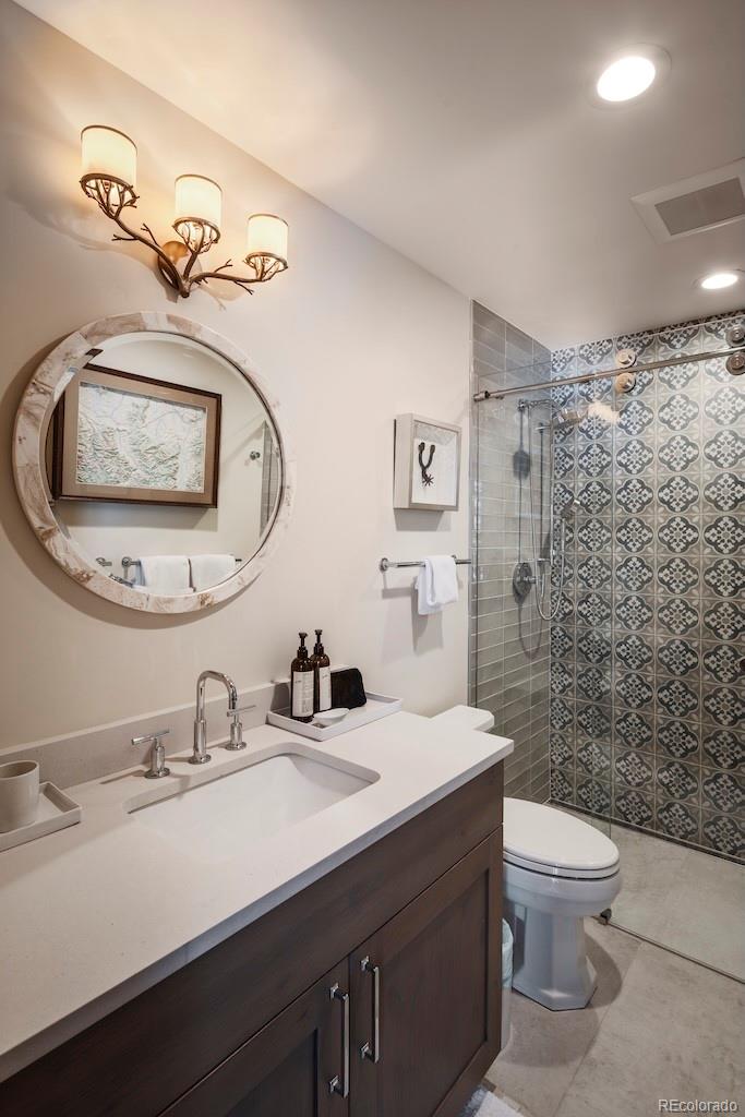 1670 Fallridge Place, Unit C11 Vail, CO 81657 - Photo 25 of 39 a bathroom with a toilet sink and mirror