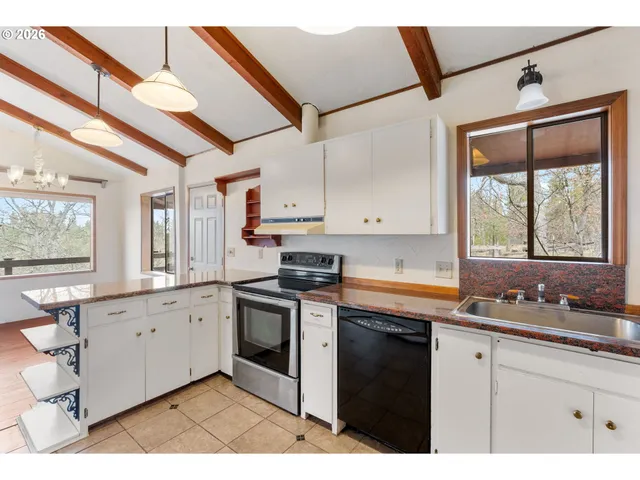a kitchen with stainless steel appliances granite countertop a sink stove and cabinets