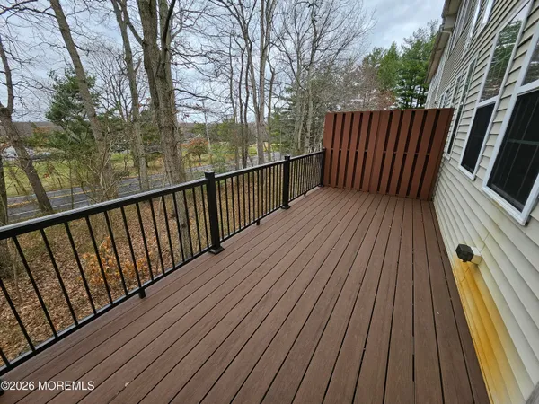 a balcony with wooden floor in front of it