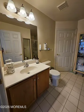 a bathroom with a sink vanity and a mirror