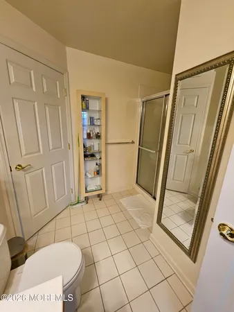 a bathroom with a toilet and a shower