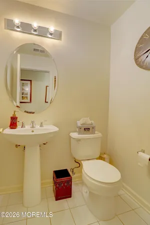 a bathroom with a sink a toilet and mirror