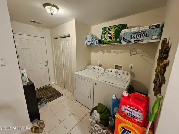 a utility room with a sink dryer and washer