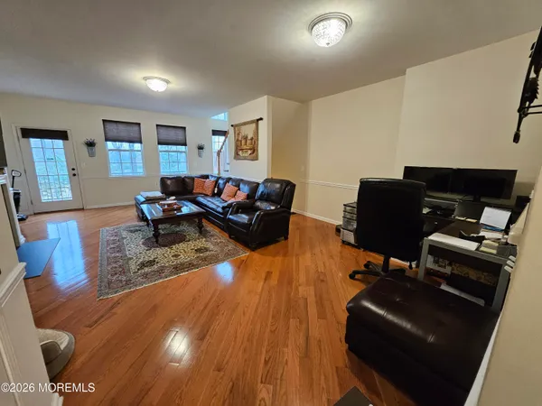 a living room with furniture and a wooden floor